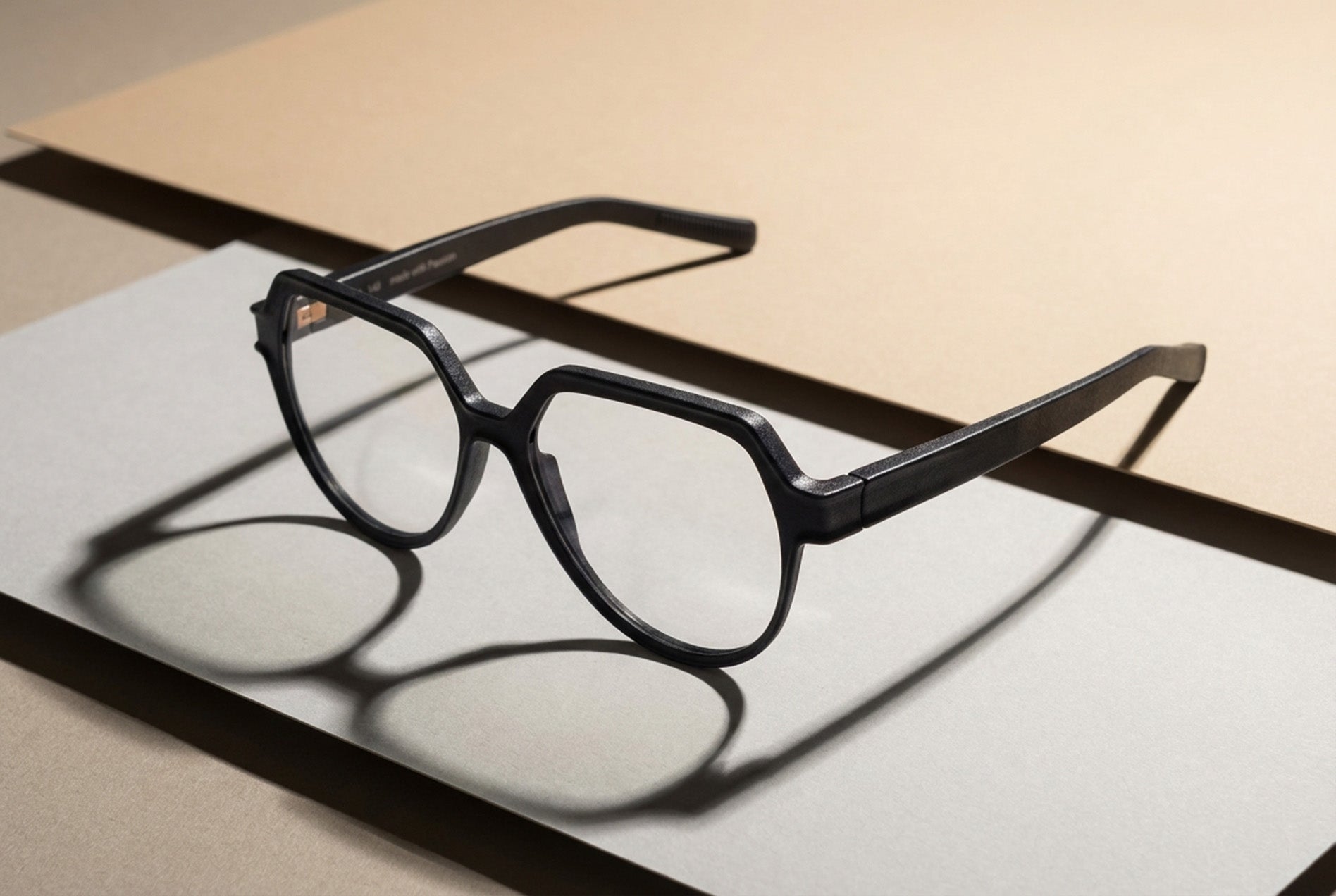 black optical frame prototype positioned on studio surface highlighting eyewear design proportions
